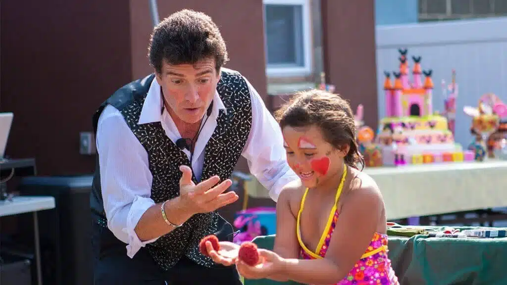 a magician and girl with face paint