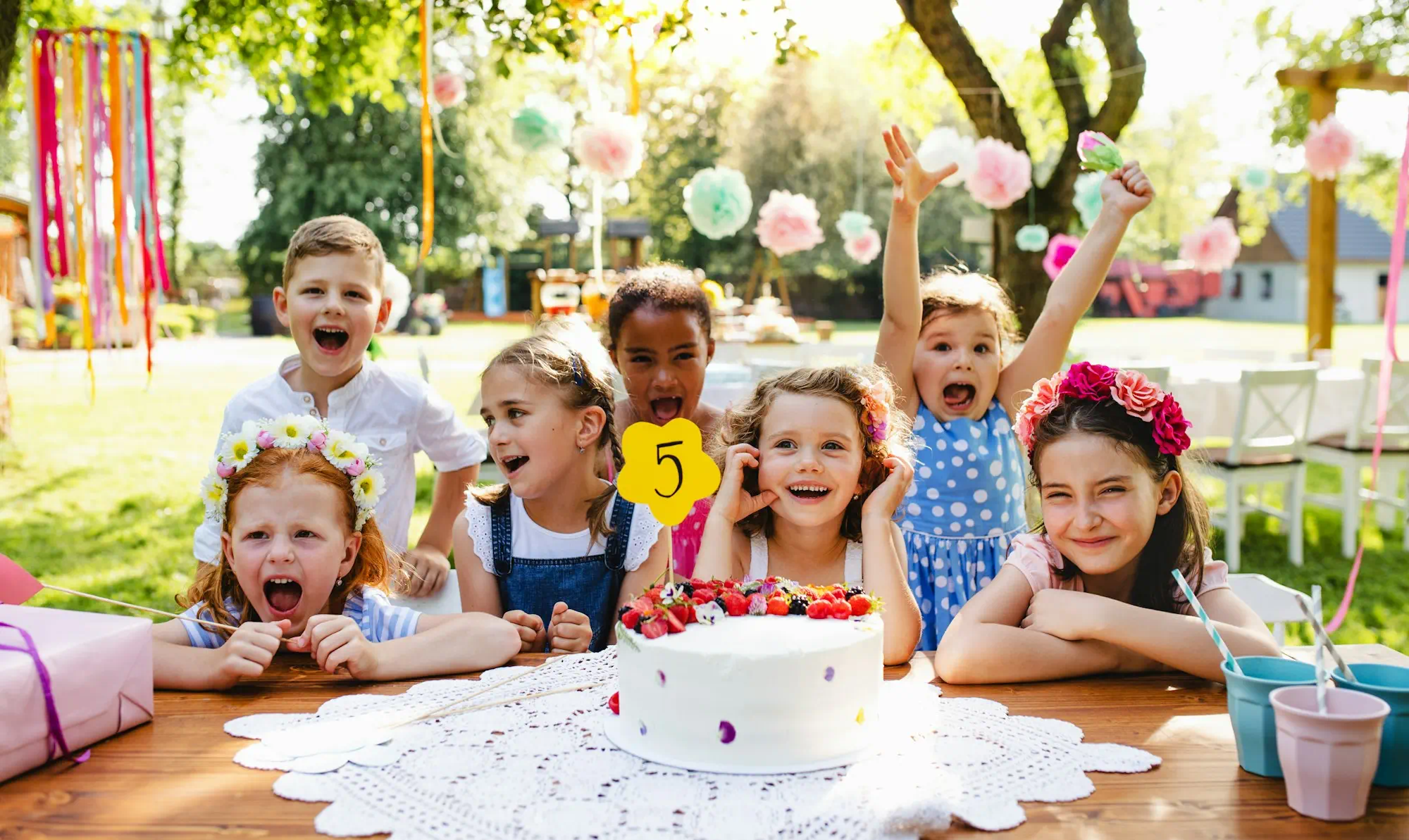 children cheering at a birthday party