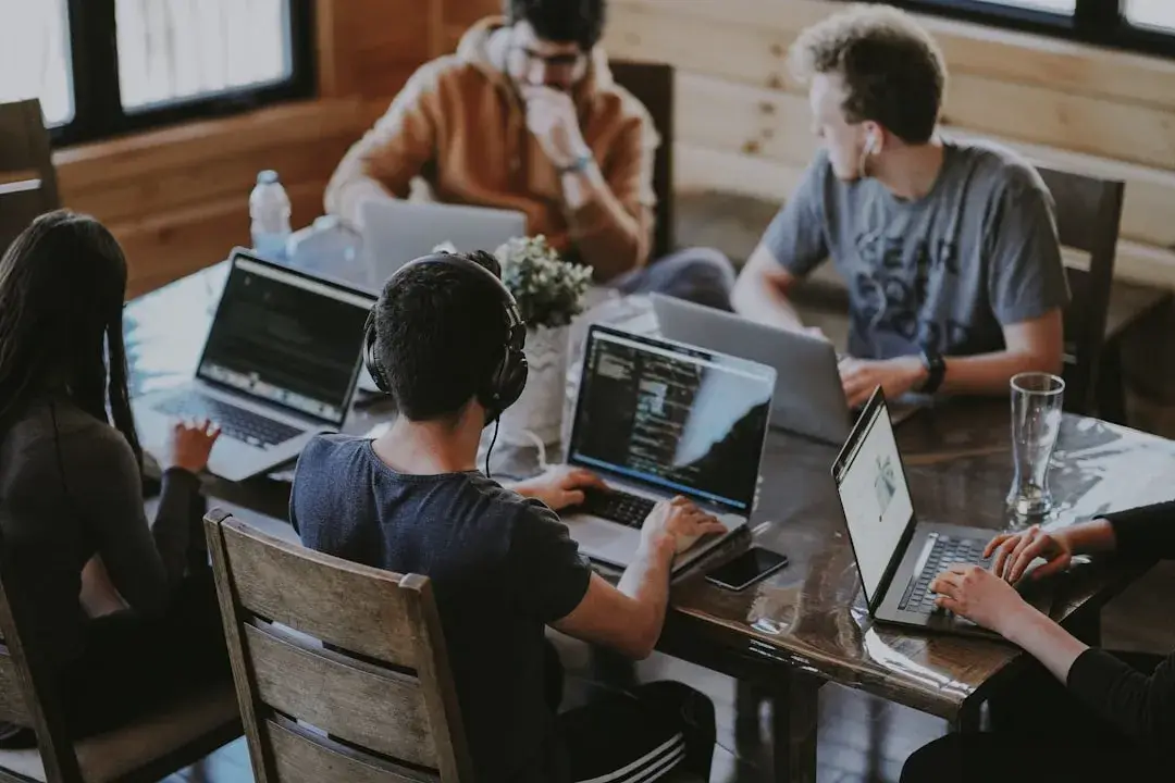 people working on a computer around the table
