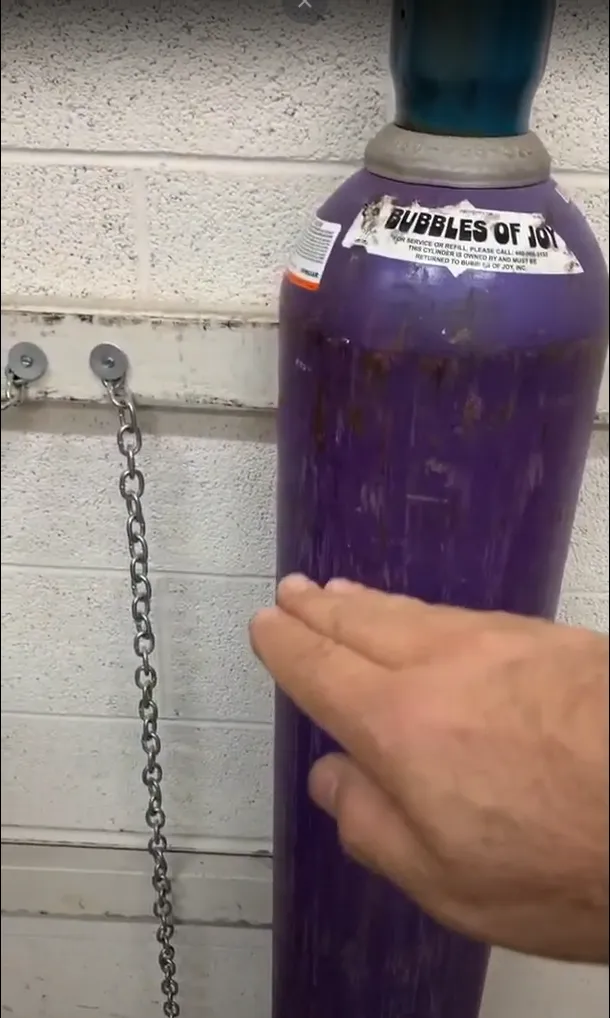 Securing a helium tank to the wall