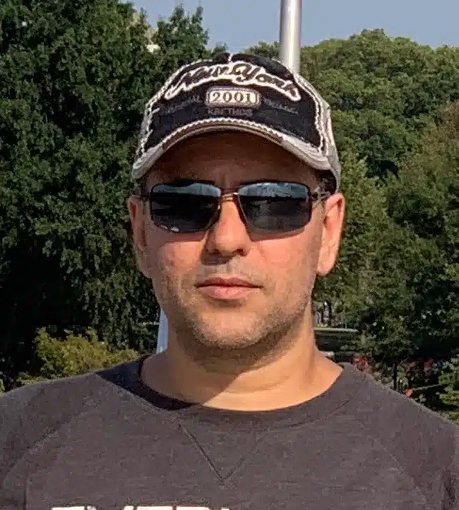 a man wearing sunglasses and a baseball cap